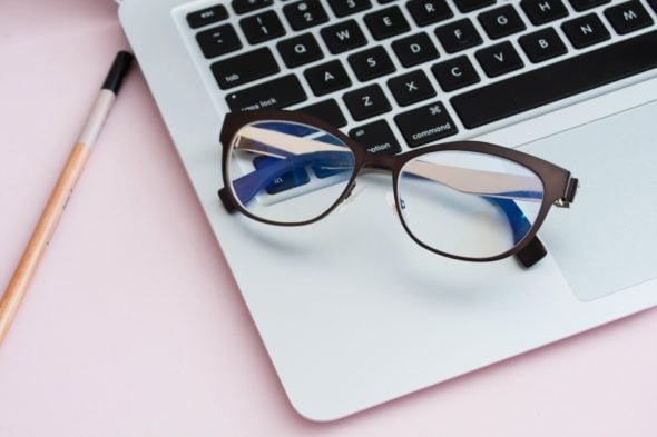 Glasses resting on laptop