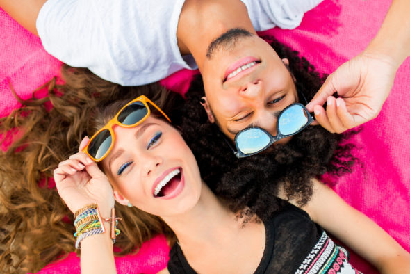 couple-laying-in-the-sun-with-their-sunglasses